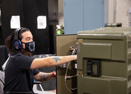 A biomedical equipment technician at the U.S. Army Medical Materiel Agency's Medical Maintenance Operations Division at Hill Air Force Base, Utah, works on a portable oxygen generator. (U.S. Army photo by Katie Ellis-Warfield/Released)
