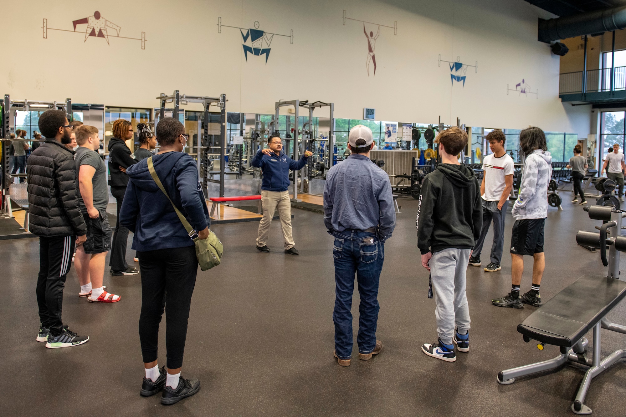 Prospective recruits tour the weight room inside the base fitness center