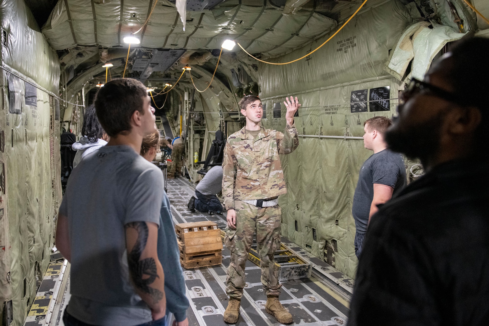 An Airman assigned to the 19th Maintenance Squadron leads prospective Airmen through a C-130J Super Hercules