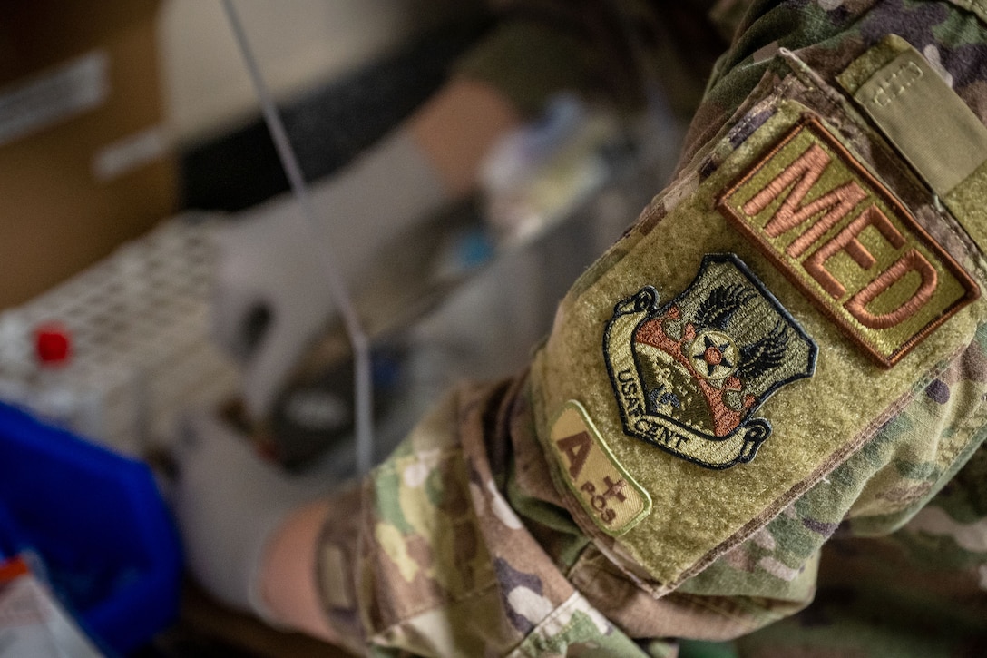 Close-up view of the sleeve of an airman's uniform with a badge reading "MED" on it.