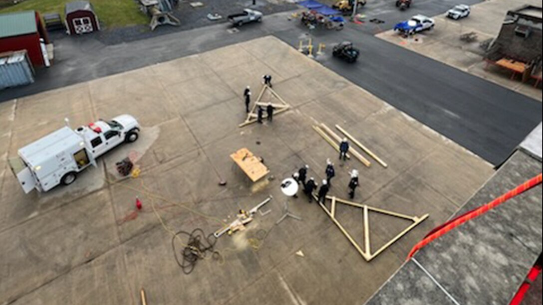 An emergency vehicle and workers outside
