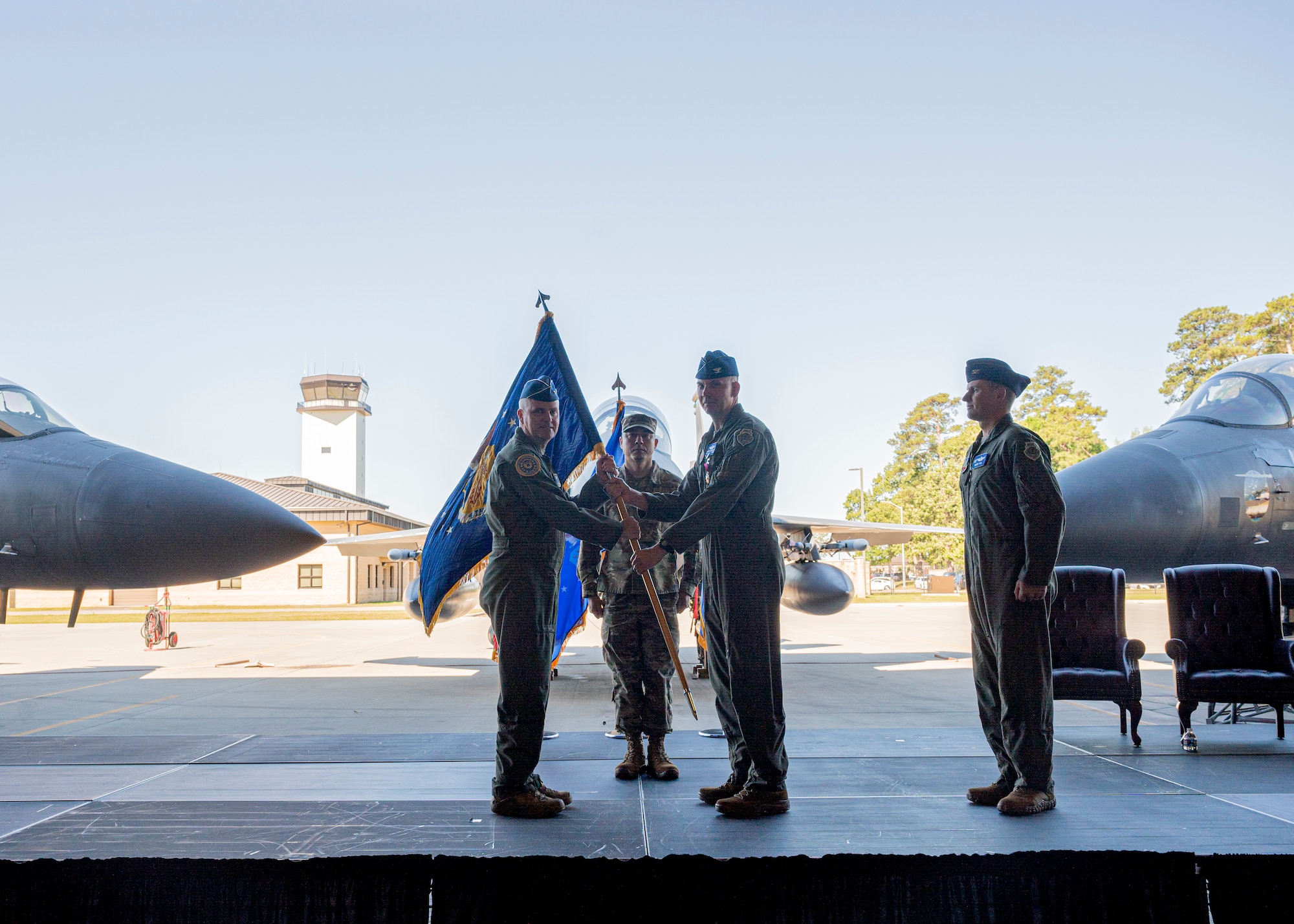 Maj. Gen. Michael G. Koscheski, left, Fifteenth Air Force commander, receives the guidon from Col. Kurt Helphinstine, outgoing 4th Fighter Wing commander, as he relinquishes command of the 4th FW during a Change of Command ceremony at Seymour Johnson Air Force Base, North Carolina, May 11, 2022. Helphinstine was the commander of the 4th FW for approximately two years. (U.S. Air Force photo by Senior Airman Kimberly Barrera)