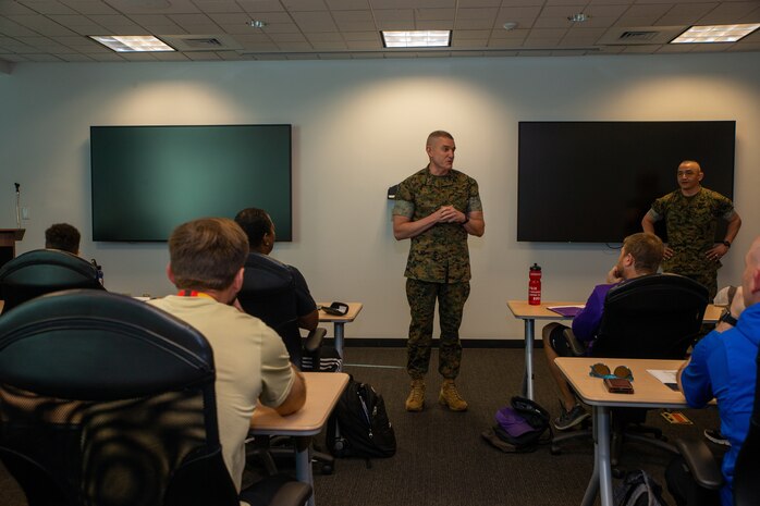 U.S. Marines Major Gen. Jason Q. Bohm, the Commanding General of Marine Corps Recruiting Command, and Sgt. Maj. Adan F. Moreno, the Sergeant Major of Marine Corps Recruiting Command, answer questions from coaches from across the United States during the Coaches' Workshop at Marine Corps Base Quantico, Virginia on May 11, 2022. The Coaches’ Workshop provides coaches and athletic directors, from  colleges and universities, the opportunity to lean how Marines are recruited, trained, and developed into leaders. (U.S. Marine Corps photo by Lance Cpl. Gustavo Romero)