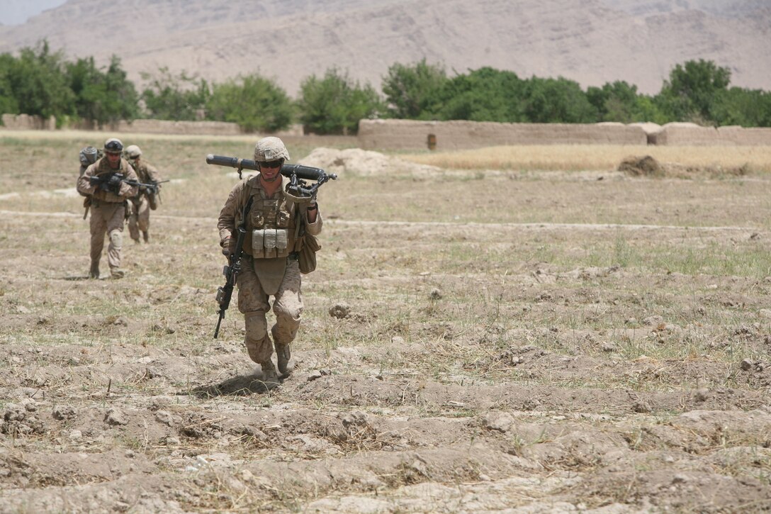 U.S. Marine Corps Lance Cpl. John R. Silvernail, front, with Golf Company, 2nd Battalion, 5th Marine Regiment, Regimental Combat Team 6 carries an M224 60 mm Lightweight Mortar as he runs for cover through an open field in Zamindawar, Helmand province, Afghanistan, May 28, 2012. Marines took enemy contact while they were conducting a patrol in the local area. (U.S. Marine Corps photo by Cpl. Christopher M. Paulton)