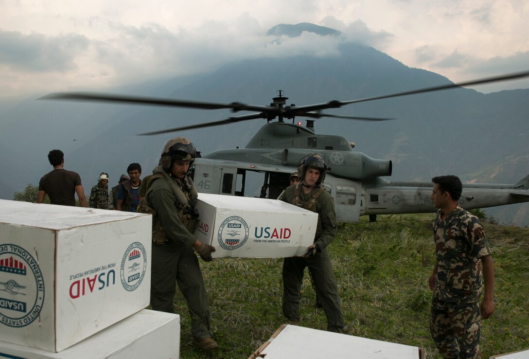 U.S. Marines and Nepalese soldiers unload tarps off of a UH-1Y Huey at Orang, Nepal, during Operation Sahayogi Haat, May 19. The Nepalese government requested assistance from U.S. Agency for International Development after the 7.8 magnitude earthquake struck their country April 25. In response, the U.S. military sent service members as part of Joint Task Force 505 at the direction of USAID. JTF 505 continues to work hand in hand with the Nepalese government through USAID. (U.S. Marine Corps photo by Cpl. Isaac Ibarra/Released)