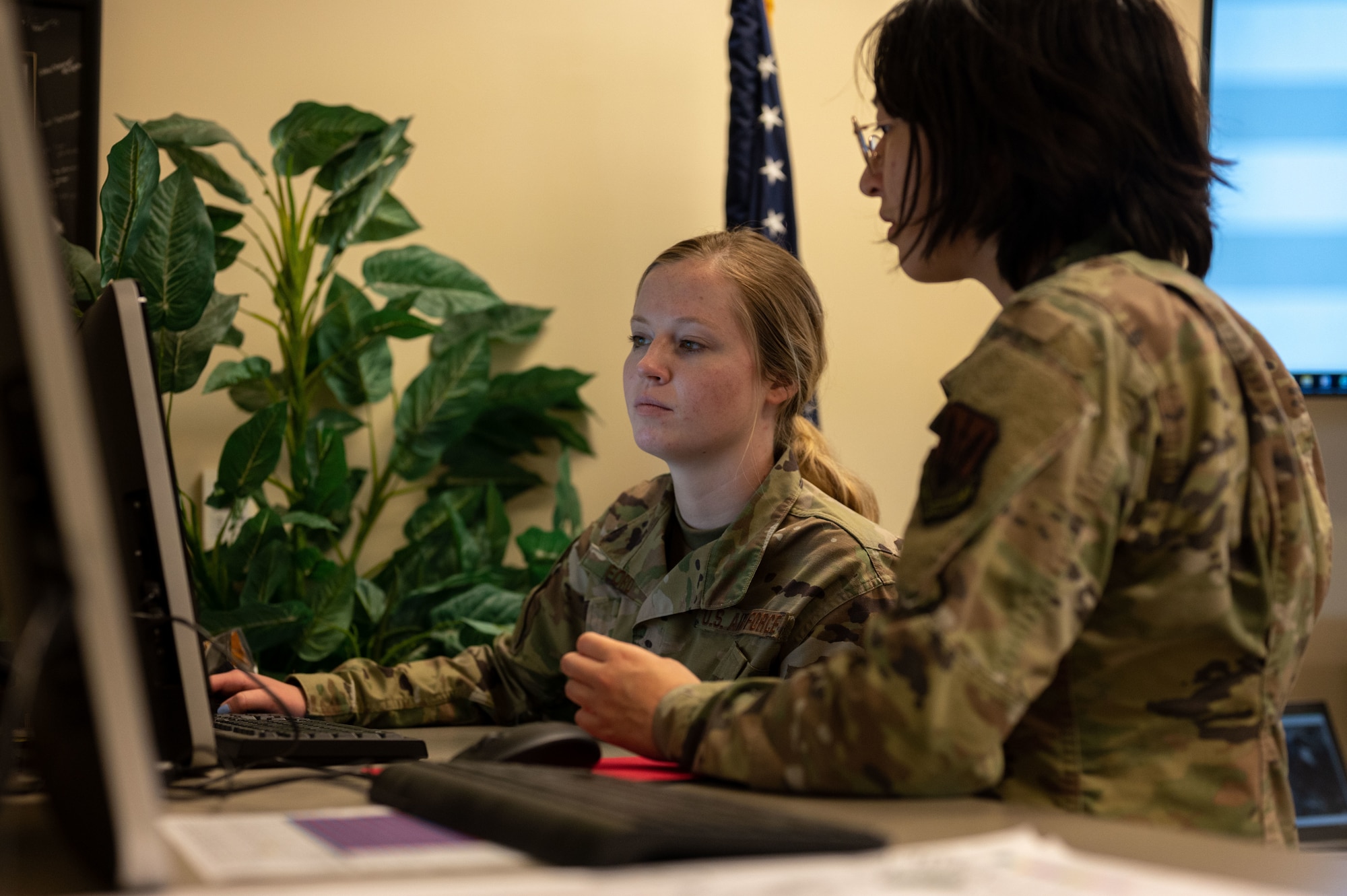 Airmen look at computer