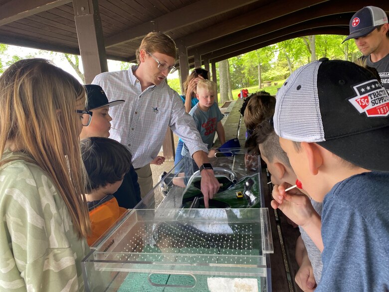 Civil Engineer Gabe Wagner used a miniature town replica to show a group of Union Elementary STEAM students how rain fall can cause major flooding if there aren’t proper dams and structures in place during a hydropower presentation at the Old Hickory Lake picnic area in Hendersonville, Tennessee on May 4, 2022.