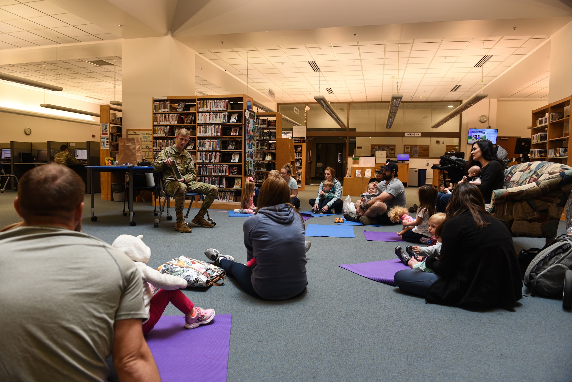 U.S. Air Force Airman 1st Class Keatan Haack, 627th Communications Squadron cyber security analyst, reads a book during McChord Field Library children's story time as part of Asian American and Pacific Islander Heritage Month celebration at Joint Base Lewis-McChord, May 11, 2022. This year's theme, "Advancing Leaders Through Collaboration," recognizes the collective benefits resulting from a spirit of community, cooperation and cultural engagement. (U.S. Air Force photo by Master Sgt. Julius Delos Reyes)