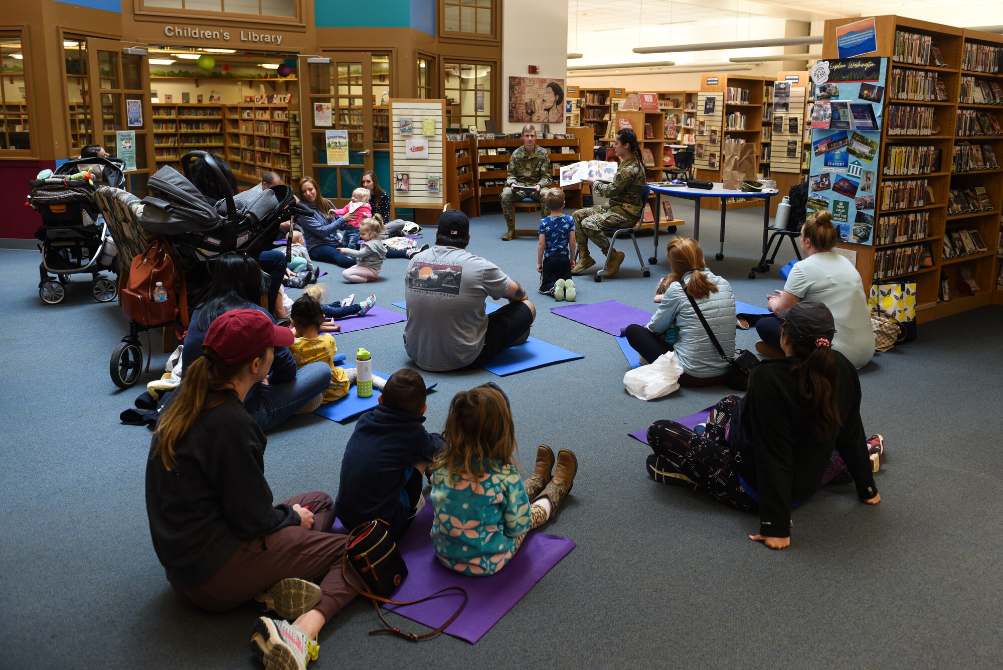 U.S. Air Force Senior Airman Alexandra Freeman, 627th Communications Squadron cyber operator, reads a book during McChord Field Library children's story time as part of Asian American and Pacific Islander Heritage Month celebration at Joint Base Lewis-McChord, May 11, 2022. This year's theme, "Advancing Leaders Through Collaboration," recognizes the collective benefits resulting from a spirit of community, cooperation and cultural engagement. (U.S. Air Force photo by Master Sgt. Julius Delos Reyes)