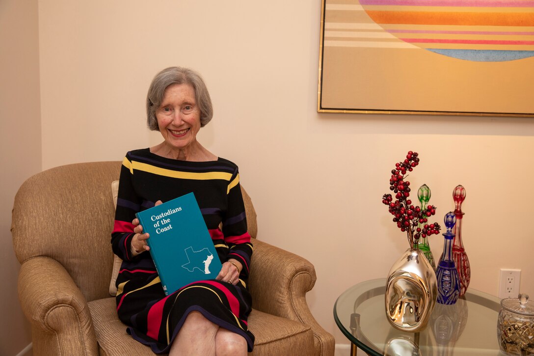 GALVESTON, Texas -- Lynn Alperin poses for a photo with a copy of her book, "Custodians of the Coast," at her home, April 7. The retired medical writer recently gifted the U.S. Army Corps of Engineers (USACE) Galveston District’s historical archives a signed copy of her book after learning there weren’t any copies left in its libraries. For a long time, Alperin’s book was considered required reading for incoming district commanders.

Photo by Carlos Gomez