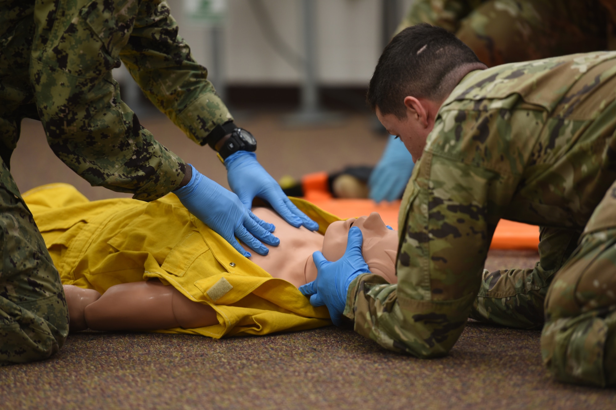 Joint service students assigned to the 312th Training Squadron, palpate a simulated victim’s chest during their Emergency Medical Responder psychomotor evaluation at Goodfellow Air Force Base, Texas, May 6, 2022. Students were divided into teams of three and were required to complete the assessment in less than 10 minutes. (U.S. Air Force photo by Senior Airman Abbey Rieves)