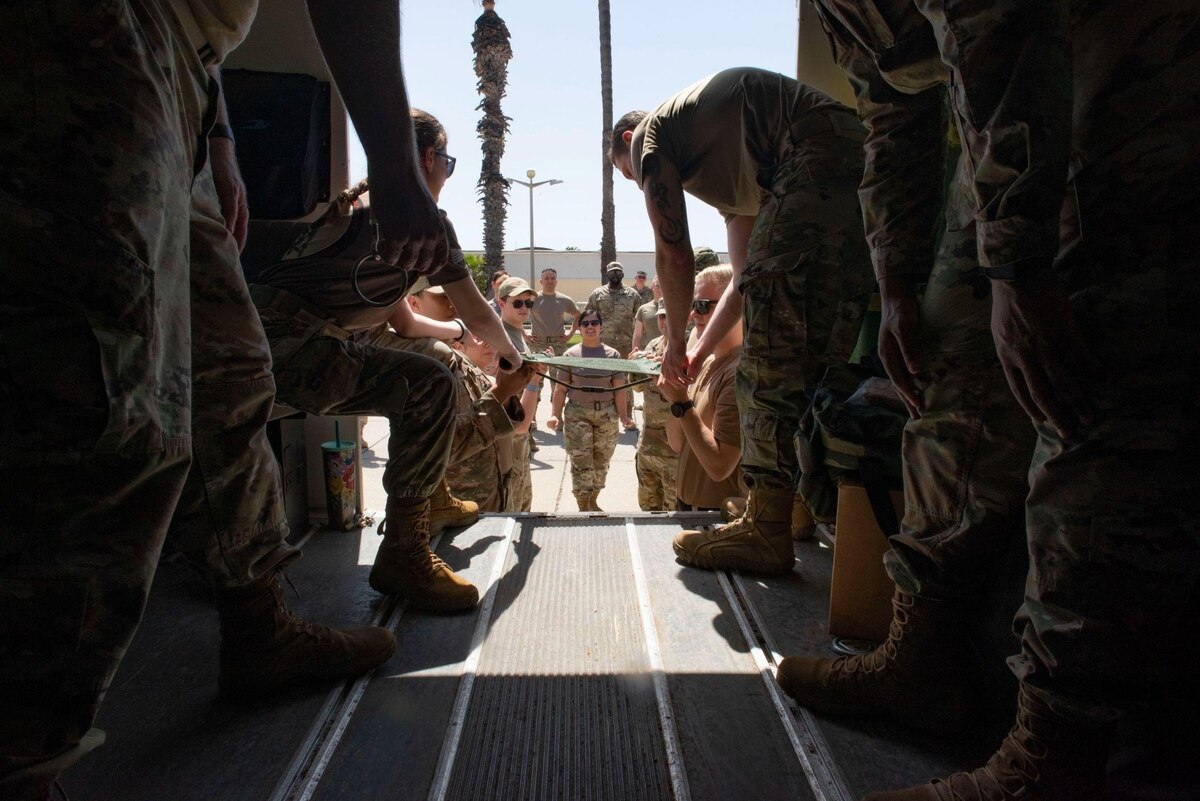 Airmen, Soldiers and NATO allies from various units across Incirlik Air Base practice patient loading techniques during the first combined Medic-X and Tactical Combat Casualty Care course hosted by the 39th Medical Group at Incirlik Air Base, Turkey, April 23, 2022. The five-day course integrated multi-capable airman concepts into the existing TCCC curriculum to prepare all medics for prolonged field care. The Air Force Medical Service tasked the 39th MDG to beta test a combined curriculum making this the first training of its kind in the Air Force. (U.S. Air force photo by Staff Sergeant Gabrielle Winn)