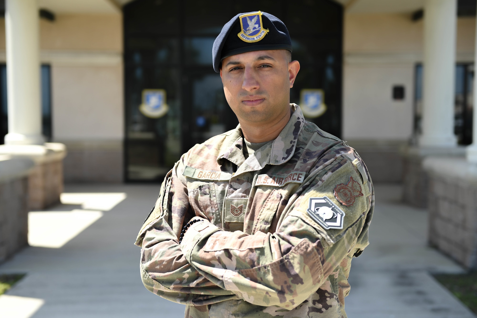 U.S. Air Force Tech. Sgt. Urich Garcia, 45th Security Forces Squadron supra coder, stands outside the 45th SFS building at Patrick Space Force Base, Fla., April 25, 2022. Supra coders have to complete a software development bootcamp that teaches full-stack javascript development and application deployment before receiving the title of supra coder.