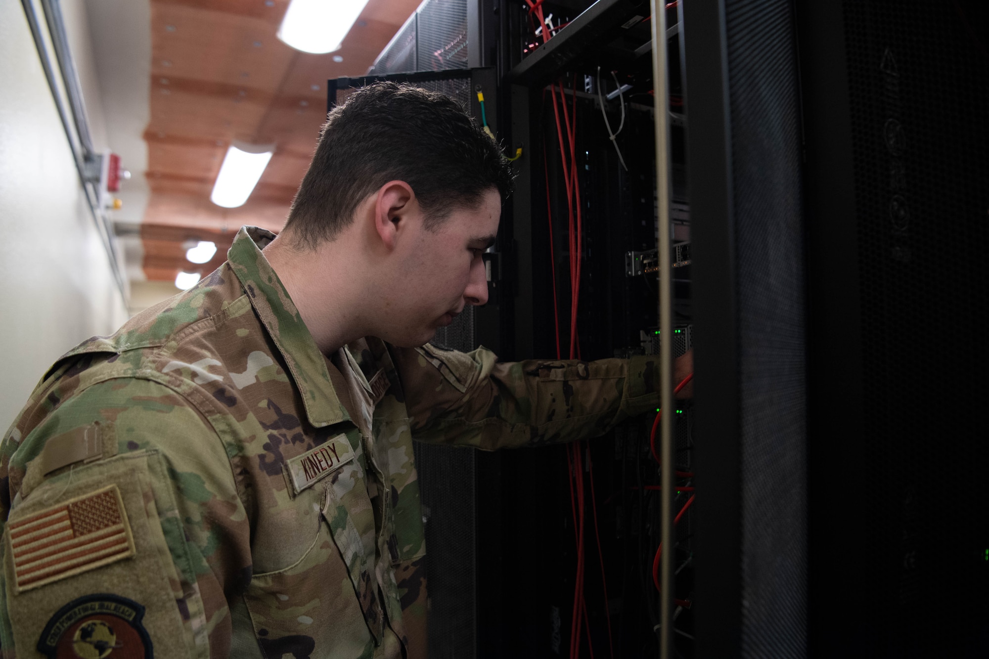 3.	Senior Airman Nathan Kennedy, 608th Air Communications Squadron system administrator, inspects servers in the 608th ACOMS data center. An important part of his job is to ensure all systems are on and running 24/7 with the most current upgrades.  (U.S. Air Force photo by Staff Sgt. Bria Hughes)