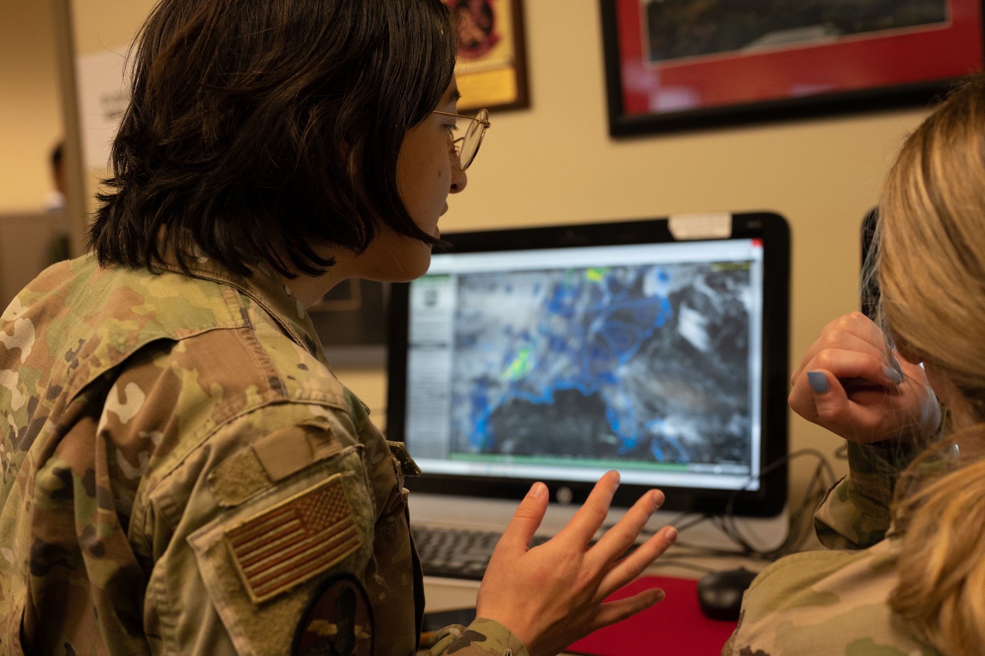 Airmen look at computer