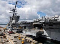 Crews load munitions onto the Nimitz-class aircraft carrier USS Nimitz (CVN 68) in preparation for future routine operations during a visit to Naval Magazine Indian Island, Wash., May 9, 2022.