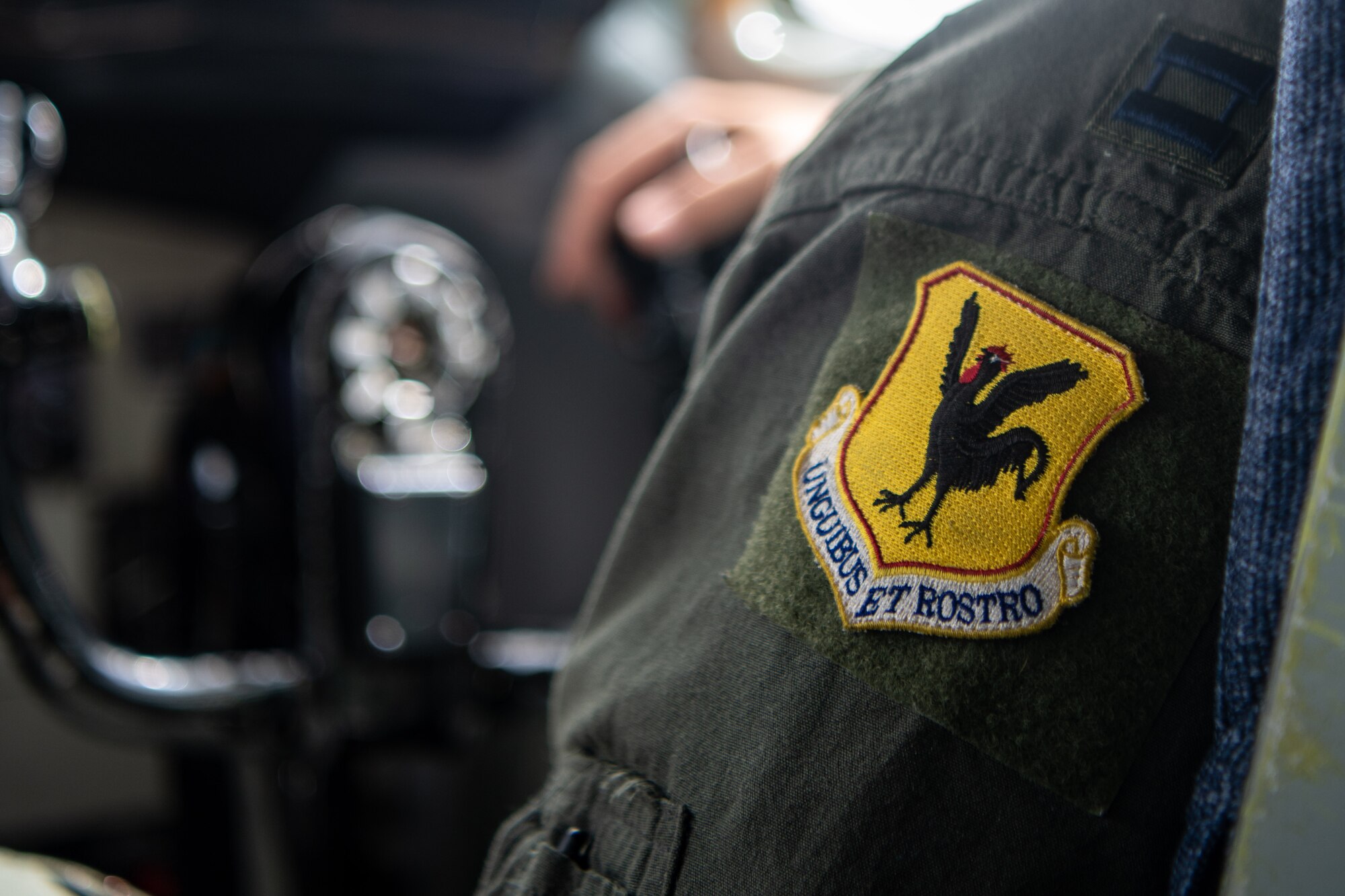 An 18th Wing patch is displayed on a pilot's uniform.