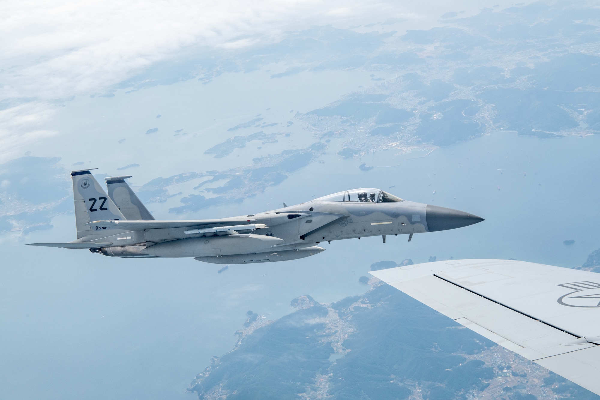 An F-15 Eagle flies across the Pacific Ocean.