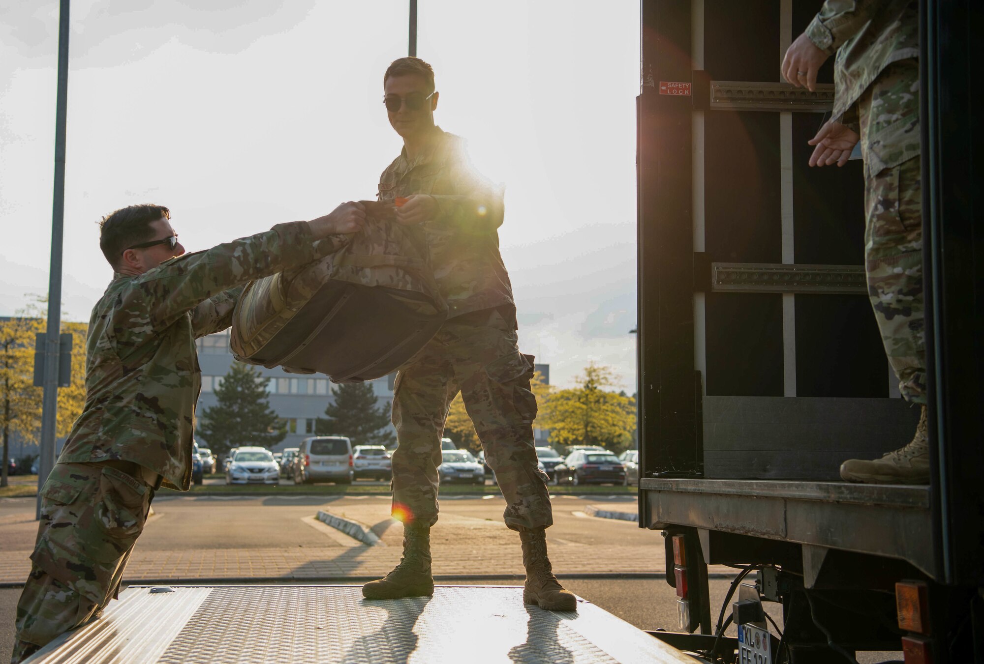 U.S. Air Force Staff Sgt. Robert Rogers, 86th Mission Support Group Detachment 1 Deployment Transition Center resiliency trainer, loads redeployers’ bags into a truck before transporting it to lodging at Ramstein Air Base, Germany, May 3, 2022.