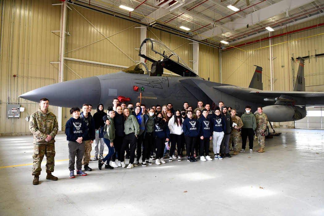 Chiopee High School JROTC posed for a group photo in front of a static F-15 Eagle. Students came into the hangar to look at the jets and understand how they are cared for at the 104th Fighter Wing. (U.S. Air National Guard courtesy photo)