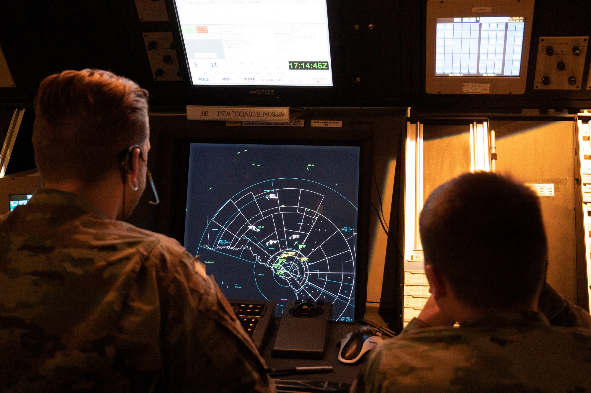 U.S. Air Force Airman 1st Class Christopher Morley (left), and Airman 1st Class Caze Bradley (right), 47th Operations Support Squadron air traffic controllers, work together during a simulated air traffic control session at Laughlin Air Force Base, Texas, May 4, 2022. The simulator allows Airmen to train for day-to-day air traffic scenarios without the stress of real-world situations. (U.S. Air Force photo by Airman 1st Class Kailee Reynolds)