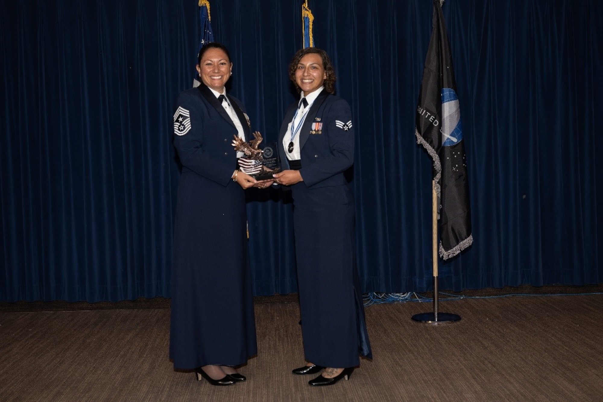 Airman is presented award from senior enlisted leader