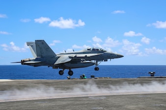 VAQ) 133 conduct flight operations from USS Abraham Lincoln in the Philippine Sea.