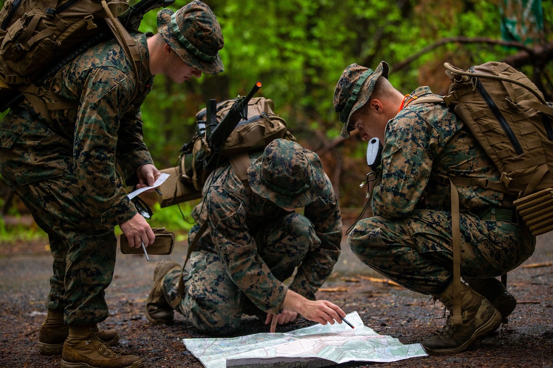 U.S. Marines with 3rd Marine Logistics Group, conduct land navigation during the Iron Mike competition at The Basic School on Marine Corps Base Quantico, Virginia, May 7, 2022. Competitors from across the Marine Corps were given 12 hours to complete the over 20 mile course, which culminated the use of core skills with multiple physical challenges.