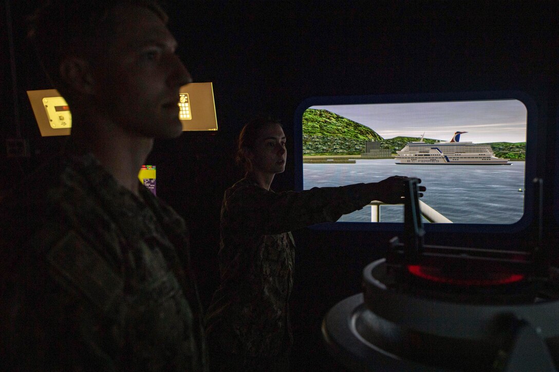 A sailor uses steers a simulator during training.