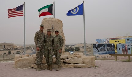 From left, U.S. Air Force Staff Sgt. Ernesto Lopez Falcon, a force support services journeyman with the 386th Expeditionary Force Support Squadron, Staff Sgt. Joanna Falcon, an operations specialist with the 332th Expeditionary Civil Engineer Squadron, and Senior Airman Jennifer Lopez Falcon, a customer support specialist with the 386th Expeditionary Logistics Readiness Squadron, reunite at the Rock at Ali Al Salem Air Base, Kuwait, April 4, 2022. All three family members were deployed to the U.S. Central Command area of responsibility at the same time from the 116th Air Control Wing, Georgia Air National Guard.