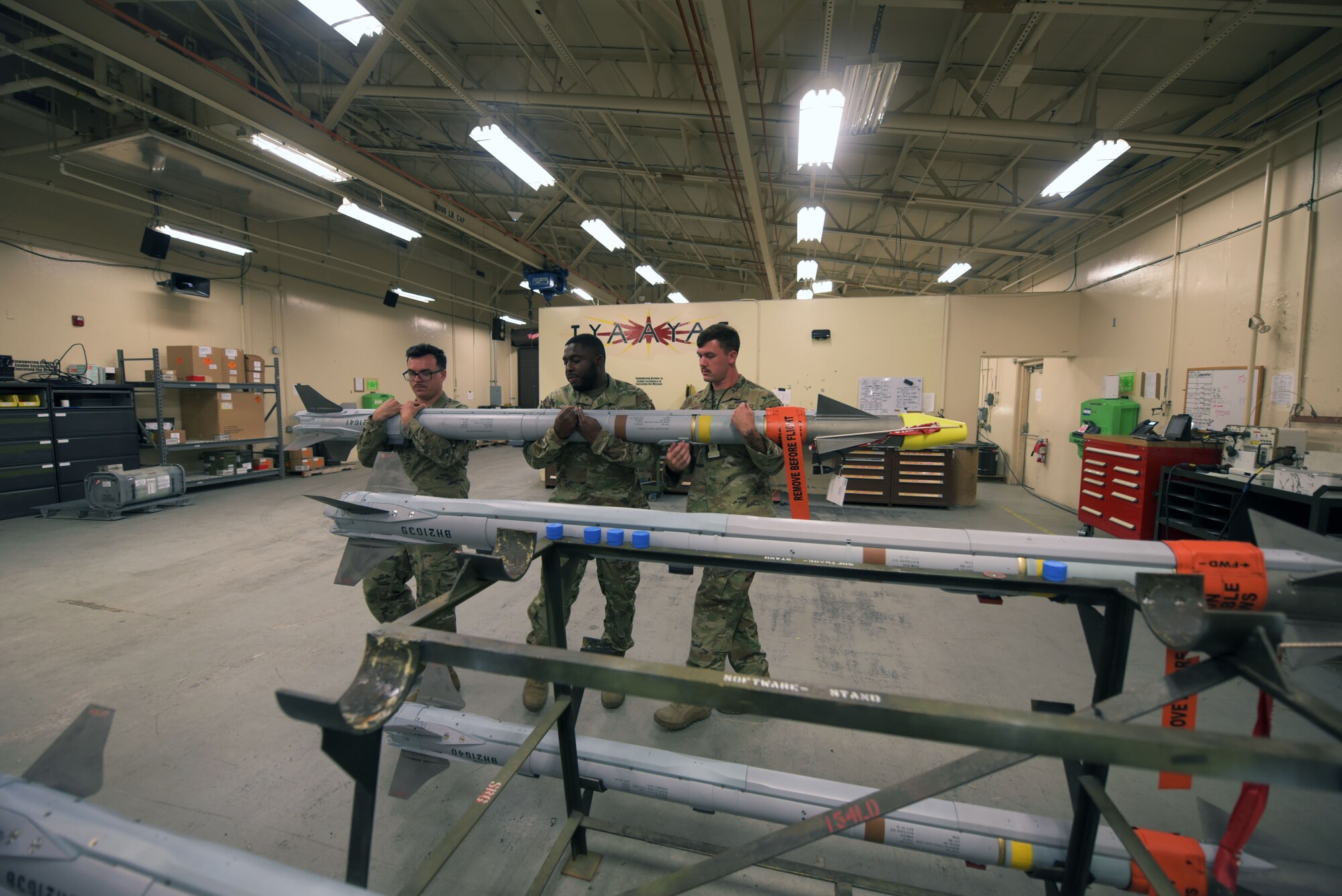 325th Munitions Squadron airmen carry AIM-9X