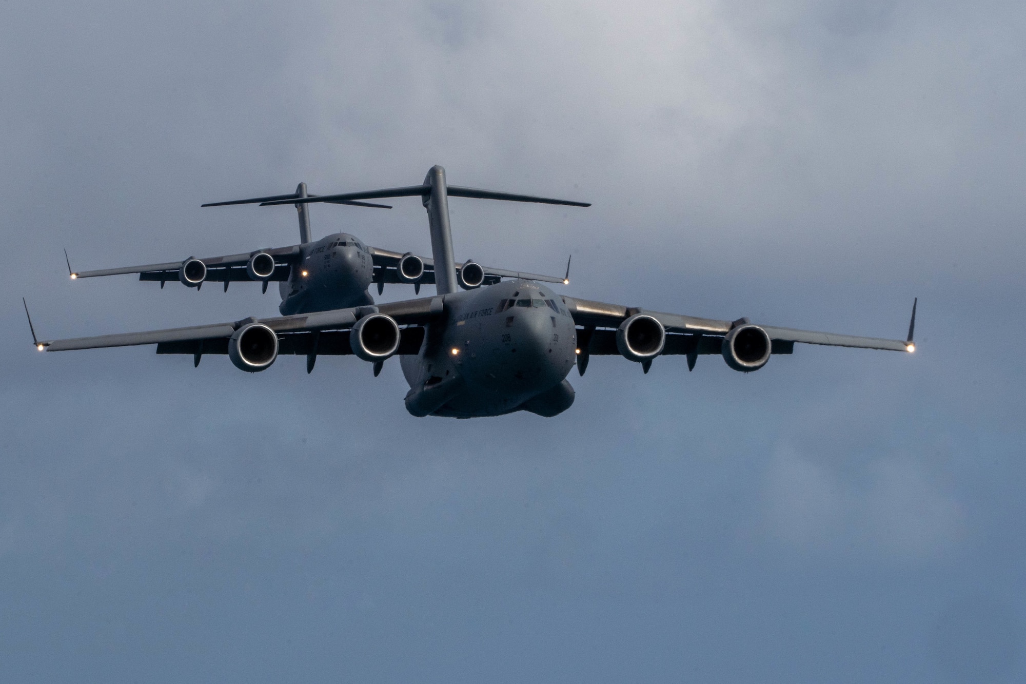 A Royal Australian Air Force C-17 Globemaster III flies in front of a U.S. C-17 during an aerial maneuver training mission around the Hawaiian islands as part of Exercise Global Dexterity 2022 at Joint Base Pearl Harbor-Hickam, Hawaii, May 4, 2022. The RAAF and USAF conducted joint flying missions alongside each other and swapped aircrew members to better learn of each others’ procedures and techniques. (U.S. Air Force photo by Airman 1st Class Makensie Cooper)