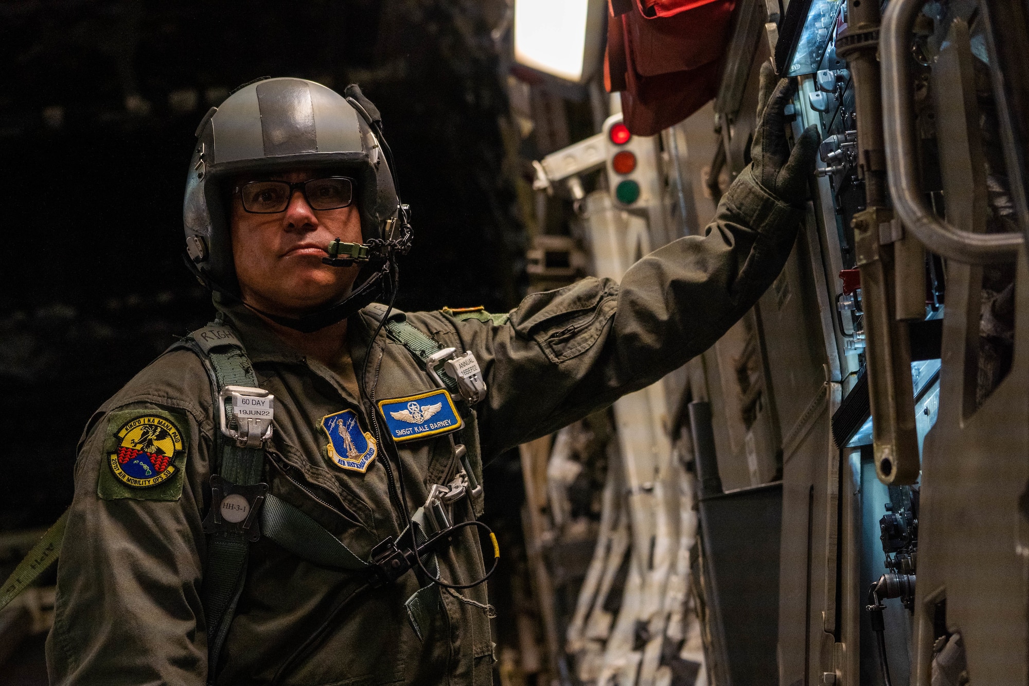U.S. Air Force Senior Master Sgt. Kale Barney, 201st Air Mobility Operations Squadron loadmaster, prepares to walk out to the ramp of a C-17 Globemaster III during Exercise Global Dexterity 2022 at Joint Base Pearl Harbor-Hickam, Hawaii, May 4, 2022. Exercise Global Dexterity 2022 is designed to help develop the bilateral tactical airlift and airdrop capabilities of the U.S. Air Force and the Royal Australian Air Force. (U.S. Air Force photo by Airman 1st Class Makensie Cooper)