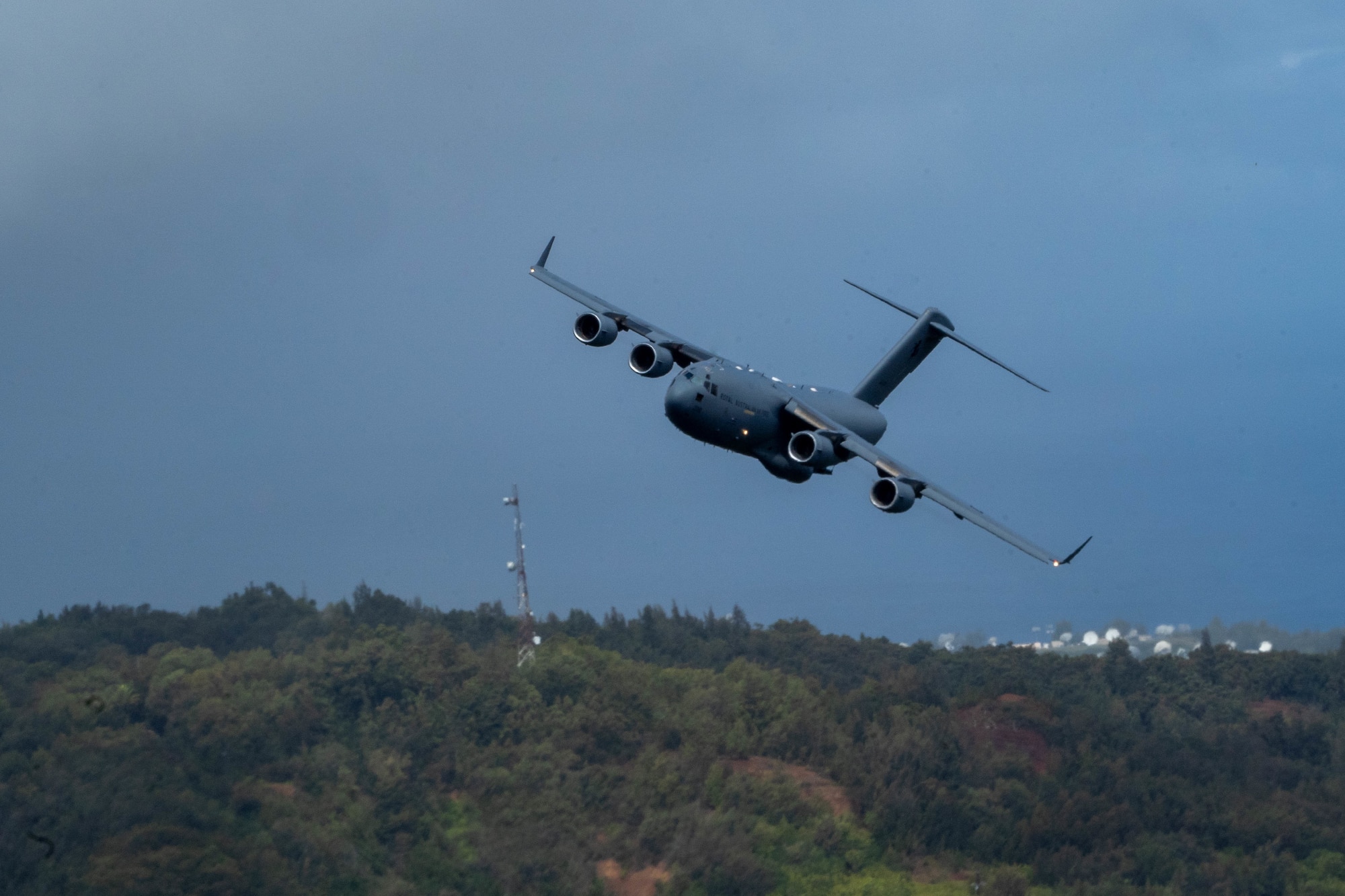 A Royal Australian Air Force C-17 Globemaster III banks over a Hawaiian Island during a training mission part of Exercise Global Dexterity 2022 at Joint Base Pearl Harbor-Hickam, Hawaii, May 4, 2022. The RAAF squadron visited JBPHH to join both active duty and National Guard C-17s for training missions around the Hawaiian Islands to develop tactical airlift and airdrop capabilities. (U.S. Air Force photo by Airman 1st Class Makensie Cooper)