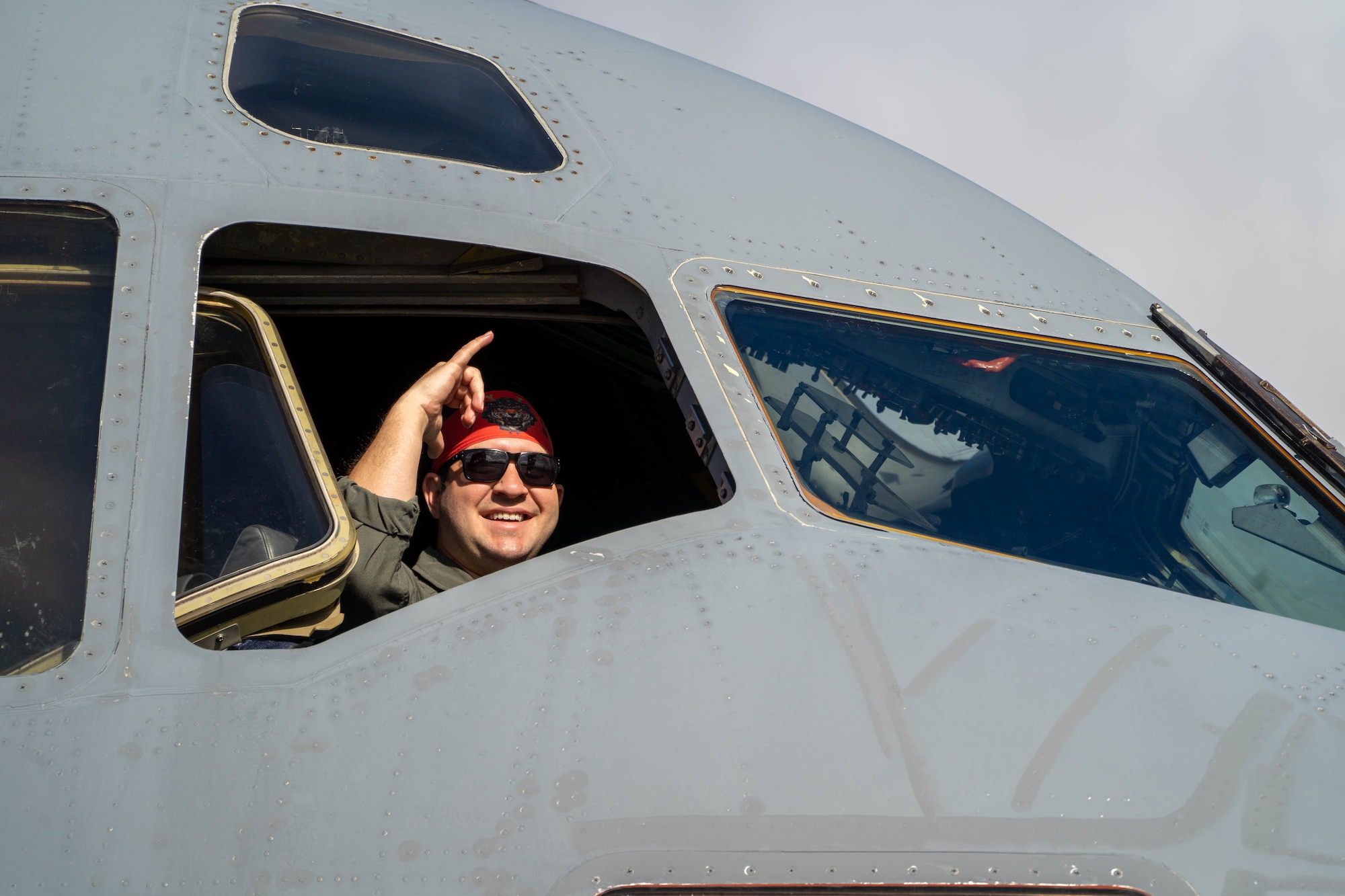 U.S. Air Force Capt. Philip Conte, 535th Airlift Squadron pilot, gestures a Hawaiian shaka from the cockpit of a C-17 Globemaster III on the flight line at Joint Base Pearl Harbor-Hickam, Hawaii, May 4, 2022. Exercise Global Dexterity is designed to prepare the U.S. Air Force and the Royal Australian Air Force for combined action in wartime, peacetime, and humanitarian operations throughout the Indo-Pacific. (U.S. Air Force photo by Airman 1st Class Makensie Cooper)