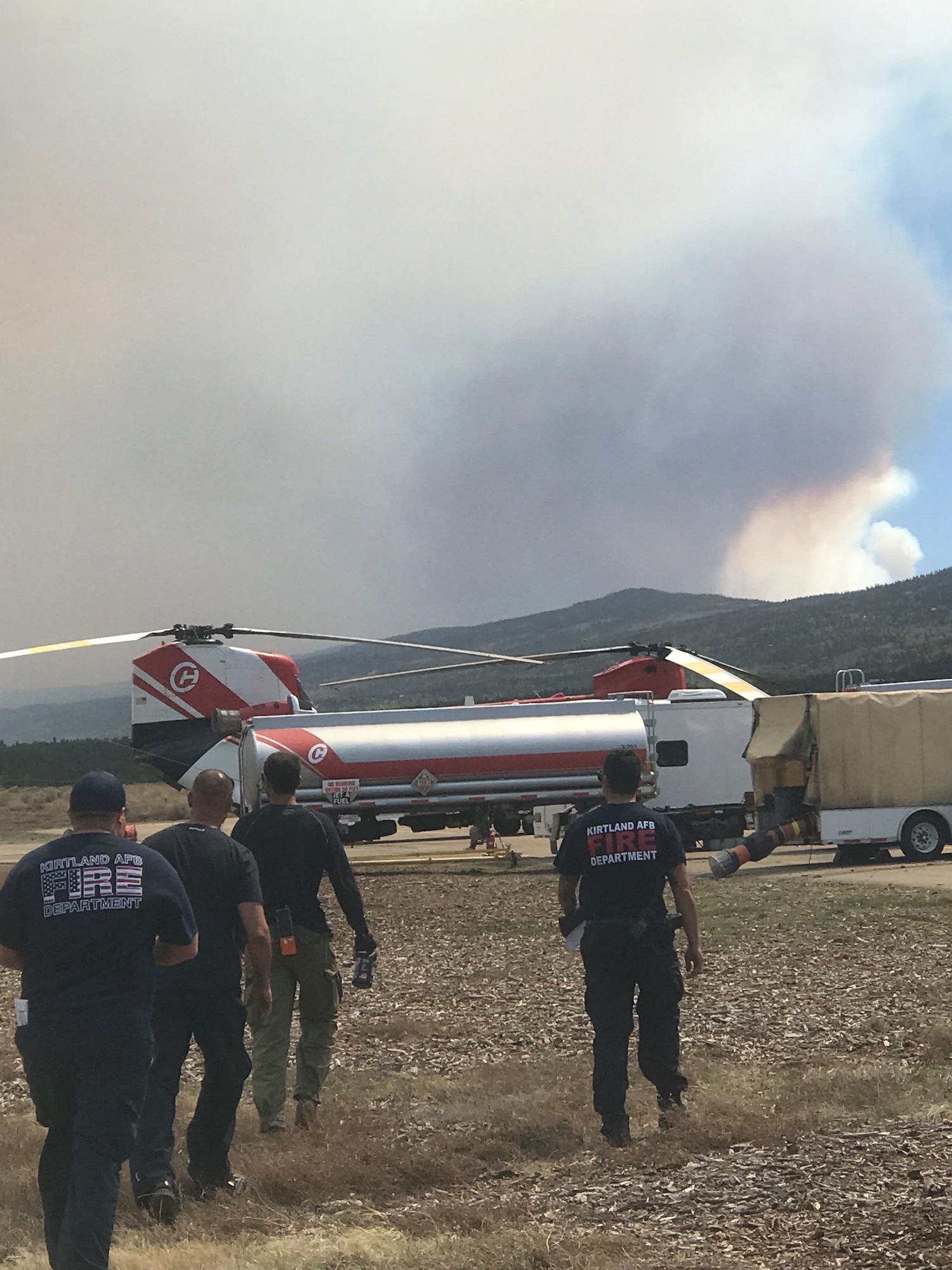 Firefighters work near an aircraft.