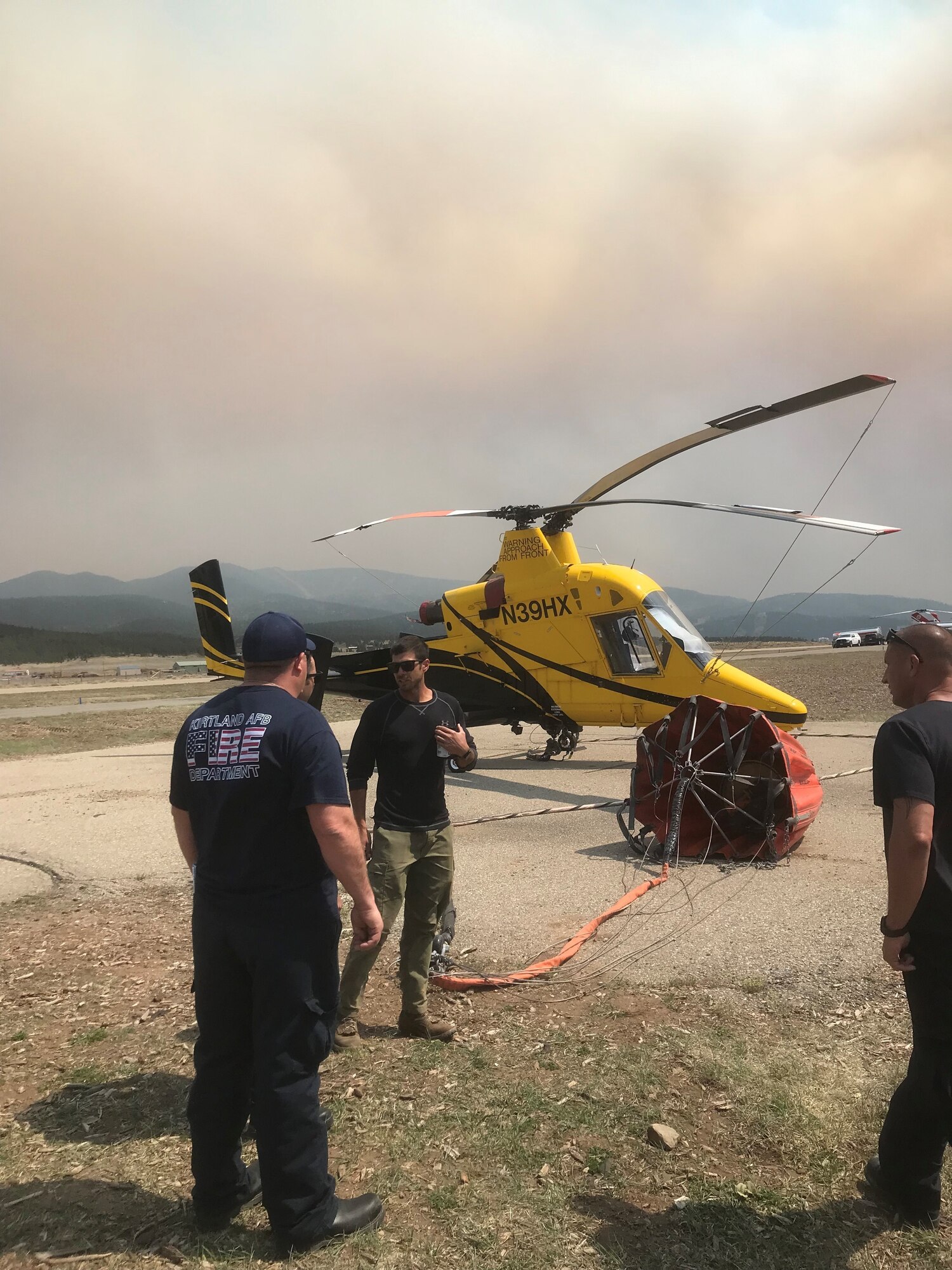 Firefighters work near an aircraft.