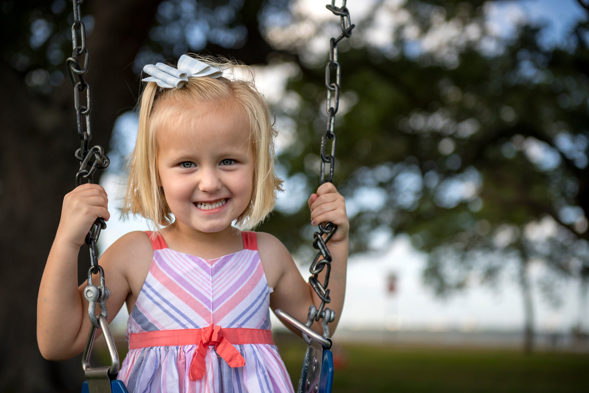 Finley Dixon, a visitor of the new all-inclusive Eagle Park Playground, sits on a swing at MacDill Air Force Base, Florida, May 11, 2022. Nearly five years since the last playground addition at Harbor Bay, the area was designed to fit the needs of children of all ages and abilities and provide interactive elements for families to gather. (U.S. Air Force photo by Airman 1st Class Lauren Cobin)