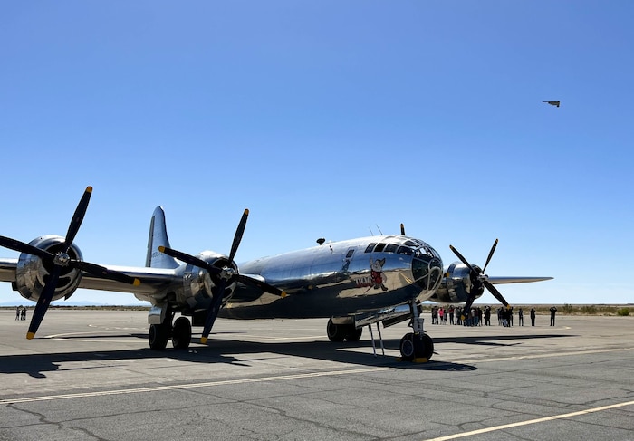 A retired U.S. Army Air Force B-29 Superfortress sits on the ramp during a B-2 Spirit flyover at Wendover Airfield, Utah, May 10, 2022. Wendover Air Field, also known as Wendover Air Force Base, was the initial training range for the 509th Composite Group. The B-29 was assigned to Wendover Air Force Base during World War II, as the weapon delivery section under the Manhattan Project.