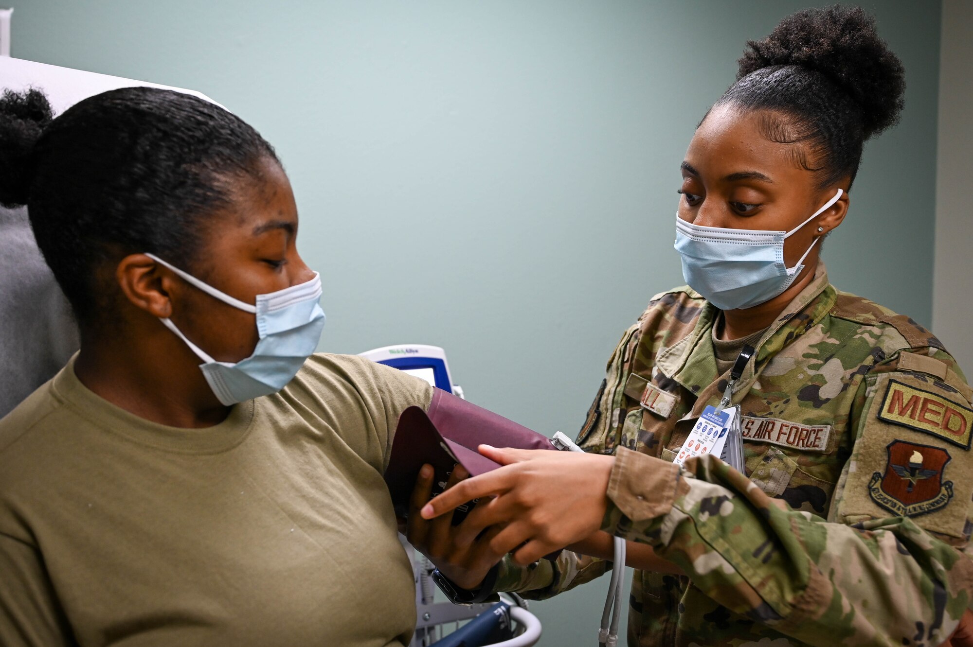 U.S. Air Force Airman 1st Class Trinity Randall, 97th Operational Medical Readiness Squadron (OMRS) medical technician, checks the blood pressure of Senior Airman Alexzandria Body, 97th OMRS front desk clerk, at Altus Air Force Base, Oklahoma, May 9, 2022. Randall said her favorite thing about being a medical technician is helping patients and she has always dreamed of being part of the medical field. (U.S. Air Force photo Senior Airman Kayla Christenson)