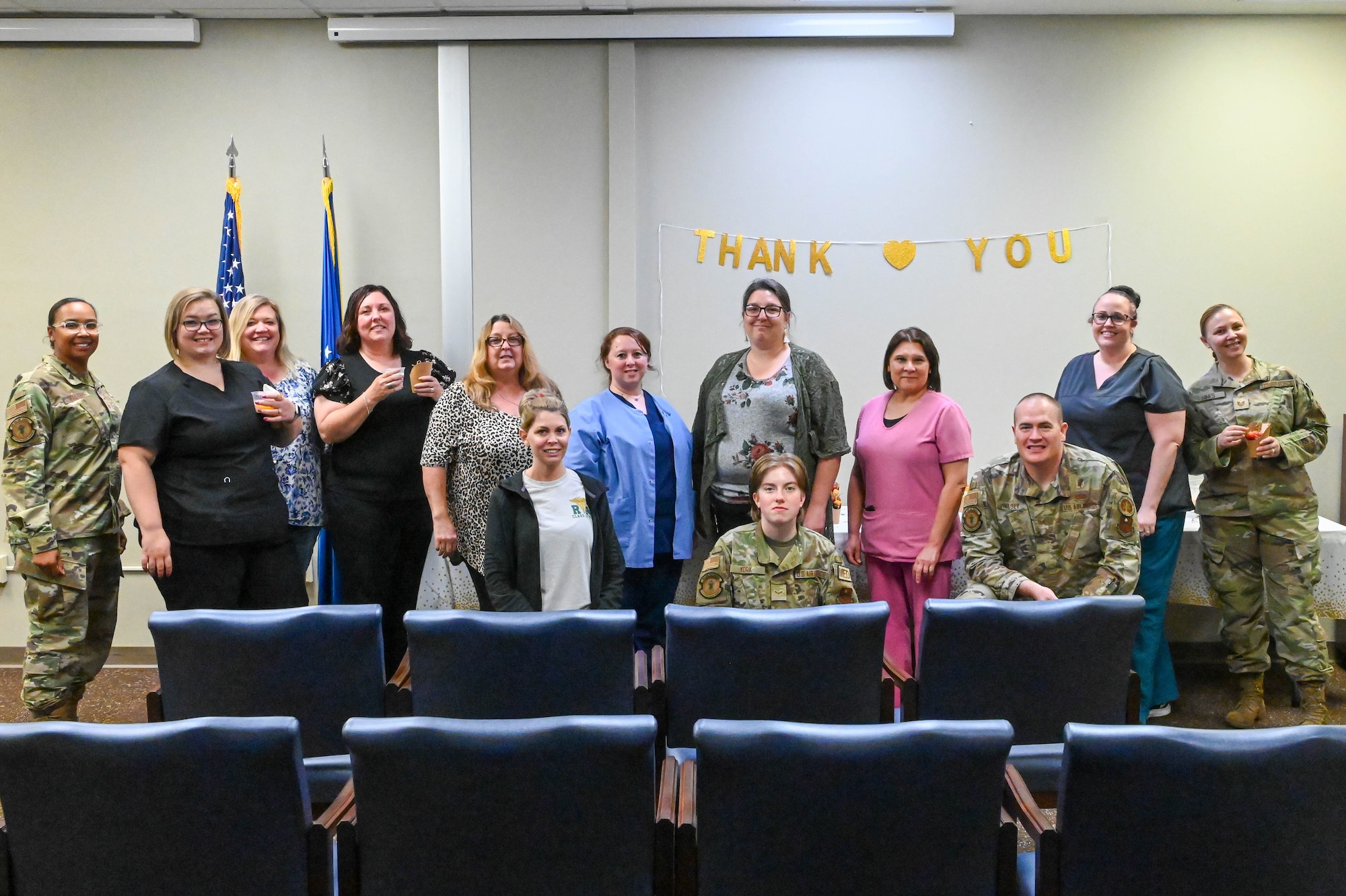 Nurses and medical technicians from the 97th Medical Group pose for a photo at Altus Air Force Base, Oklahoma, May 12, 2022. The group closed National Nurses and Medical Technicians week by celebrating with snacks and desserts. (U.S. Air Force photo Senior Airman Kayla Christenson)