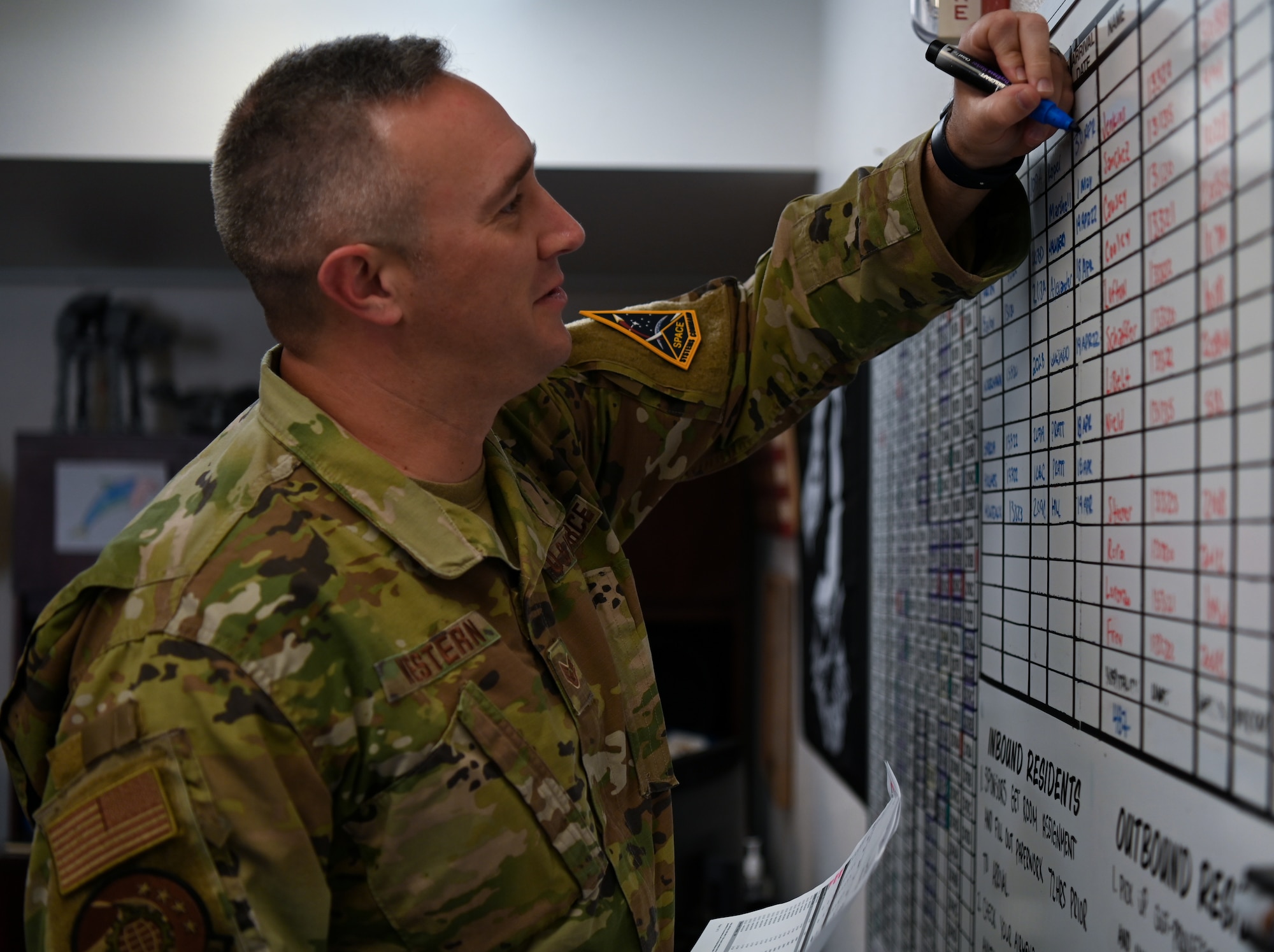 Staff Sgt. David Western, 30th Civil Engineering Squadron Airman dormitory leader, changes the board inside the dorm management office at Vandenberg Space Force Base, Calif., April 20, 2022. (U.S. Space Force photo by Airman 1st Class Tiarra Sibley)