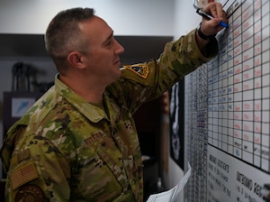 Staff Sgt. David Western, 30th Civil Engineering Squadron Airman dormitory leader, changes the board inside the dorm management office at Vandenberg Space Force Base, Calif., April 20, 2022. (U.S. Space Force photo by Airman 1st Class Tiarra Sibley)