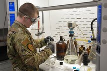 Senior Airman Conley, 5th Logistics Readiness Squadron fuels laboratory technician, analyzes fuel samples for impurities on Minot Air Force Base, North Dakota, April 27, 2022. Analyzing fuel plays a vital role in keeping the mission running properly. (U.S. Air Force photo by Airman 1st class Alexander Nottingham)