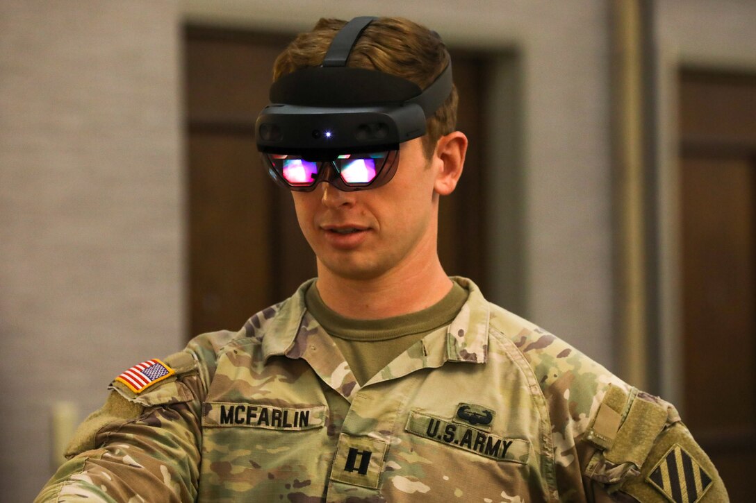 A soldier wears goggles with illuminated lenses.