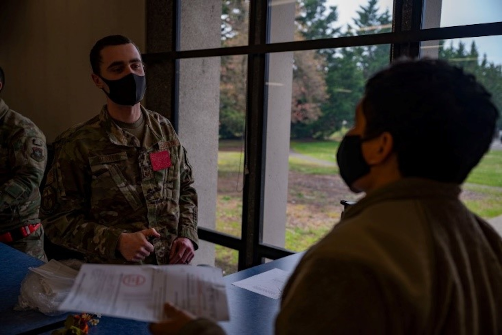 Team McChord Airmen simulate passenger check-in procedures during Patriot Express training at Joint Base Lewis-McChord, Washington, May 4, 2022. The PE mission is a commercial charter mission supporting official-duty travelers and their families to overseas locations, operating out of the McChord Passenger Terminal for the first time. (U.S. Air Force photo by Airman 1st Class Charles Casner)