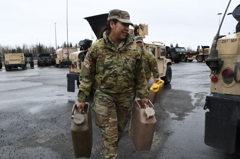 Pvt. Frederica Rivers of the Alaska Army National Guard, 207th Engineer Company loads a Humvee with additional fuel at the Fairbanks National Guard Armory in preparation to travel to Manley Hot Springs, Alaska, May 12, 2022, to support flood recovery operations. The Guardsmen will assist with cleanup and flood recovery efforts at the request of the State of Alaska Emergency Operations Center. (Alaska National Guard photo by Senior Master Sgt. Julie Avey)