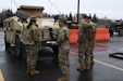 Spc. Steven Romero of the Alaska Army National Guard, 297th Military Police Company, inspects a National Guard Humvee in preparation to travel to Manley Hot Springs, Alaska, May 12, 2022, to support flood recovery operations. The Guardsmen will assist with cleanup and flood recovery efforts at the request of the State of Alaska Emergency Operations Center. (Alaska National Guard photo by Senior Master Sgt. Julie Avey)