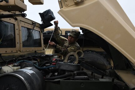 Spc. Steven Romero of the Alaska Army National Guard, 297th Military Police Company, inspects a National Guard Humvee in preparation to travel to Manley Hot Springs, Alaska, May 12, 2022, to support flood recovery operations. The Guardsmen will assist with cleanup and flood recovery efforts at the request of the State of Alaska Emergency Operations Center. (Alaska National Guard photo by Senior Master Sgt. Julie Avey)