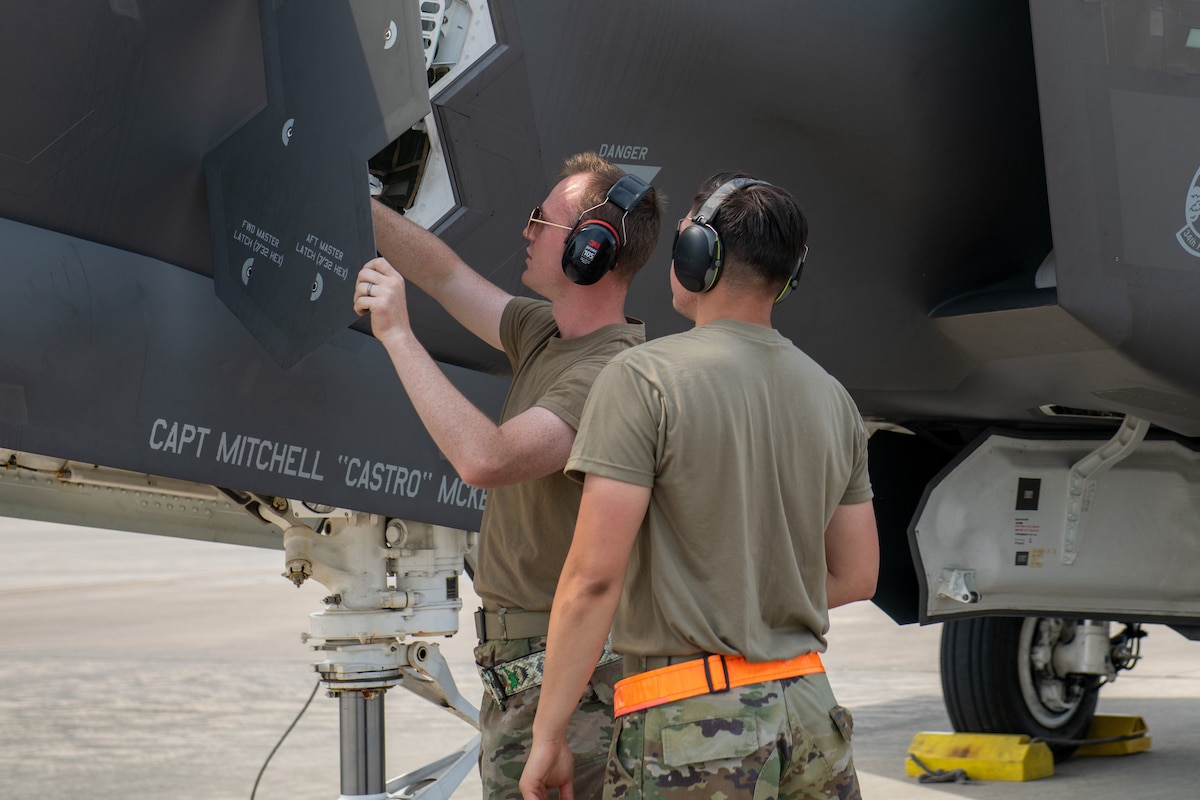 A crew chief from the 419th Fighter Wing demonstrates how to operate the F-35A Lightning II fighter jet’s ladder as part of the Multi-Capable Airman concept May 4, 2022 at the Air Dominance Center in Savannah, Georgia